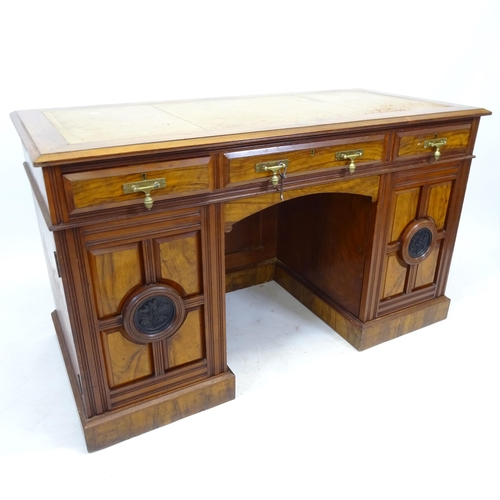 2557 - A Victorian walnut kneehole writing desk, with tooled and embossed leather skiver, drawer stamped Ma... 