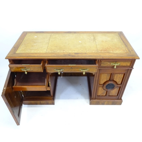 2557 - A Victorian walnut kneehole writing desk, with tooled and embossed leather skiver, drawer stamped Ma... 