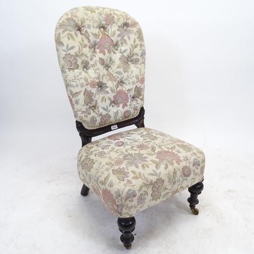 2561 - A Victorian button-back upholstered nursing chair, with ebonised frame