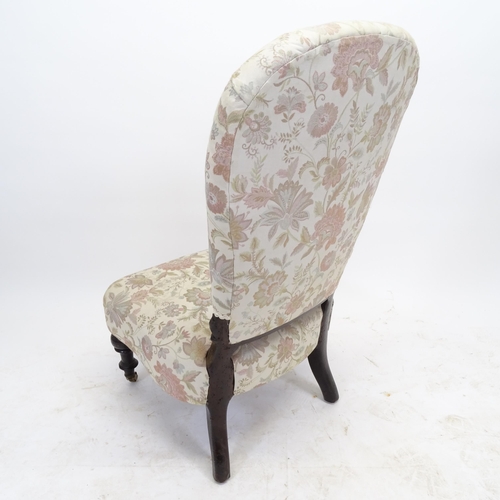 2561 - A Victorian button-back upholstered nursing chair, with ebonised frame