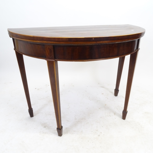 2567 - An Edwardian mahogany demilune fold over card table, on square tapered legs with spade feet, W100cm,... 