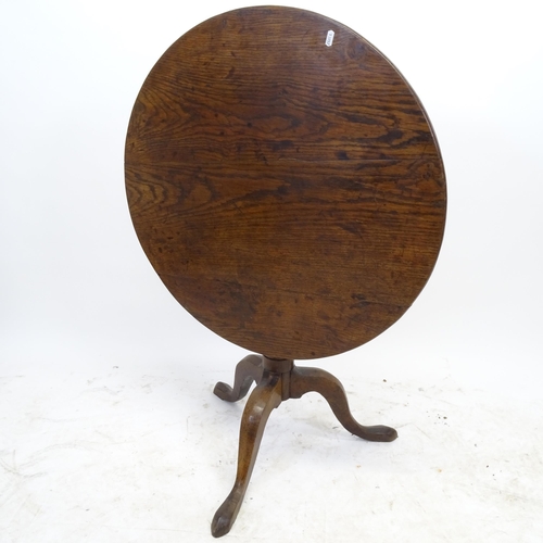 2590 - A Victorian oak circular tilt-top table, on tripod base, D75cm, H68cm