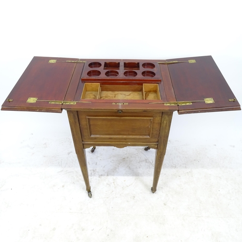 2638 - A reproduction mahogany metamorphic dressing/occasional table, with fold-out rising interior, W54cm,... 