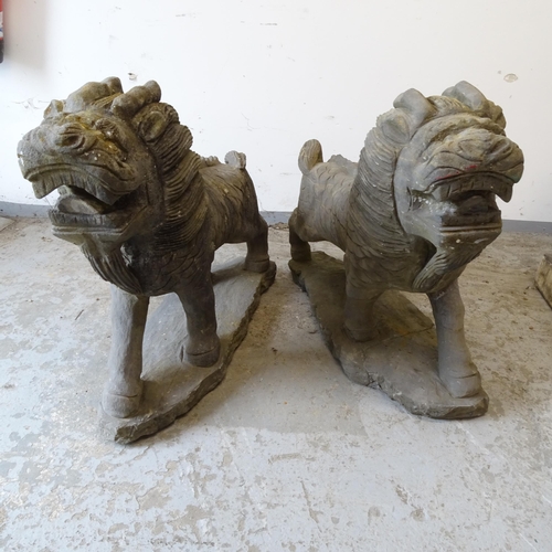 2660 - A pair of Oriental style carved stone lion sculptures, L70cm, H58cm