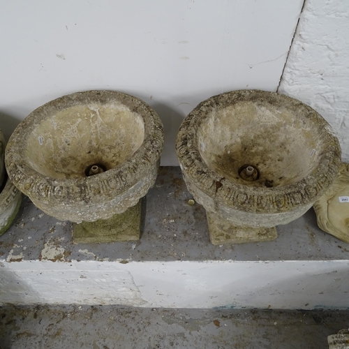 2665 - A pair of weathered concrete garden urns on stands, D44cm, H42cm