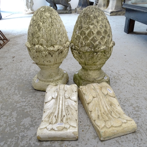 2673 - A pair of weathered concrete pineapple finials, H40cm, and a pair of composite brackets (4)