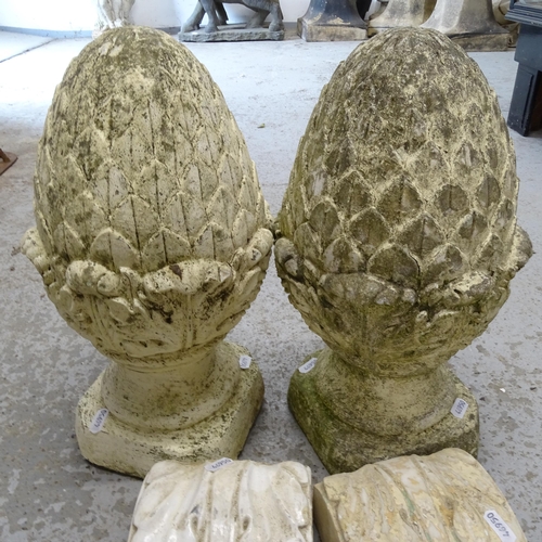 2673 - A pair of weathered concrete pineapple finials, H40cm, and a pair of composite brackets (4)