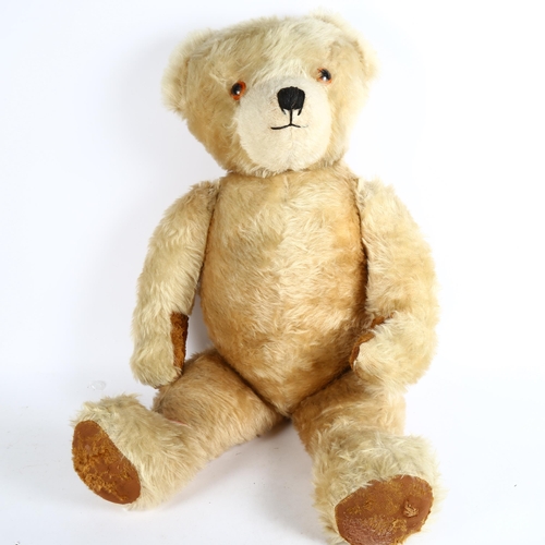 107 - A large Vintage straw-filled teddy bear, height 80cm