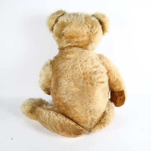 107 - A large Vintage straw-filled teddy bear, height 80cm