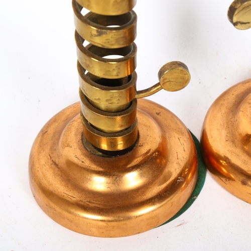 193 - A pair of brass and copper candle stands, with spiral turned handled columns, height 20cm