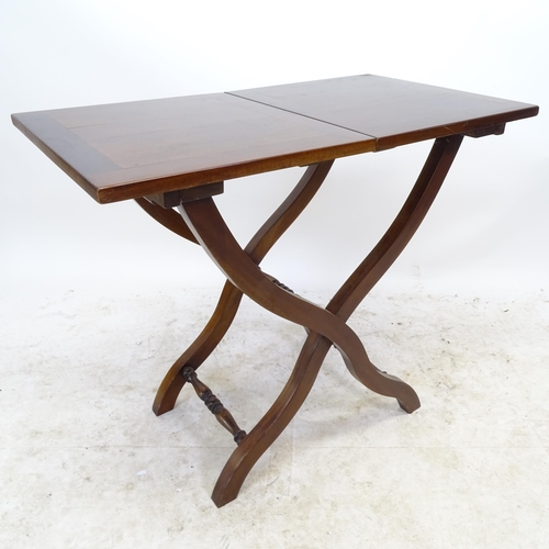 2734 - A reproduction mahogany folding coaching table on X-framed base, L82cm, H69cm, D46cm