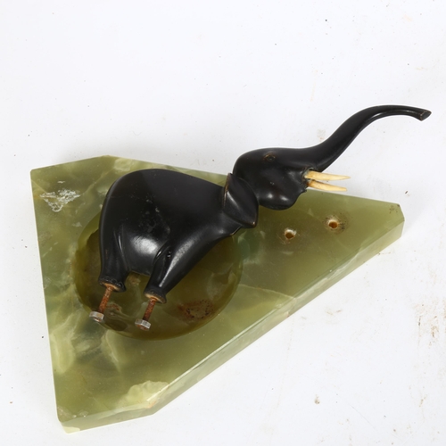 297 - Patinated bronze elephant in the manner of Hagenauer, on onyx dish base, unsigned