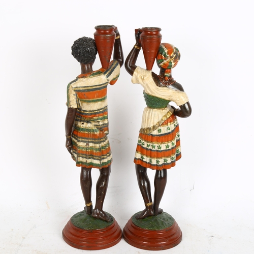 304 - A pair of painted spelter figural candlesticks, in the form of Nubian women, height 36cm