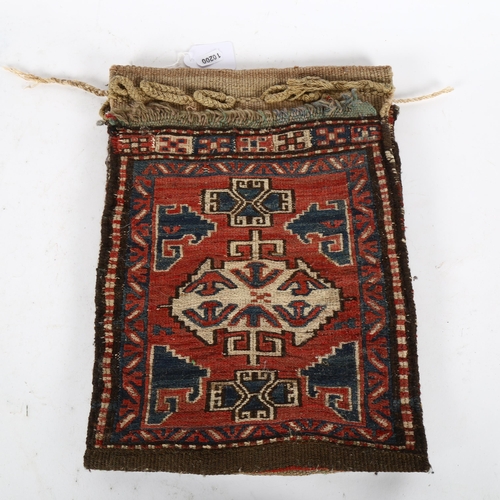 354 - An Antique red ground Afghan camel bag