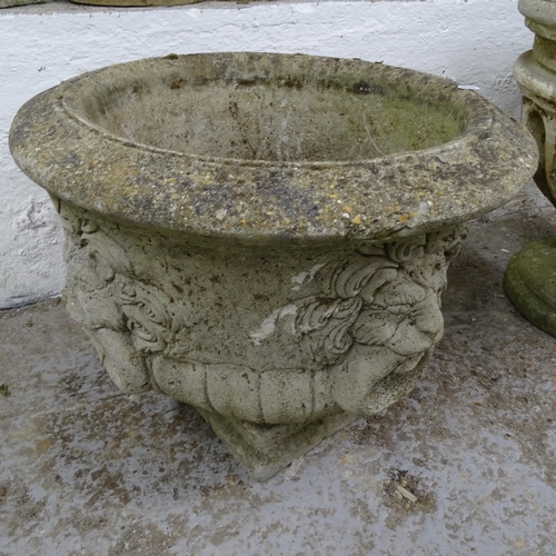 2691 - A weathered concrete circular garden urn, with lion mask decoration, D53cm, H44cm