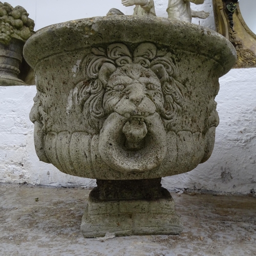 2691 - A weathered concrete circular garden urn, with lion mask decoration, D53cm, H44cm