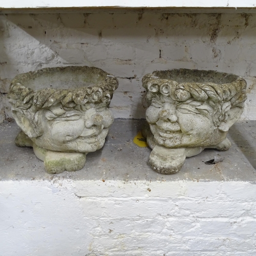 2702 - A pair of garden planters, in the form of heads, on concrete bases, W36cm, H30cm