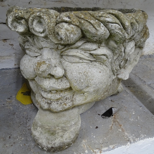 2702 - A pair of garden planters, in the form of heads, on concrete bases, W36cm, H30cm