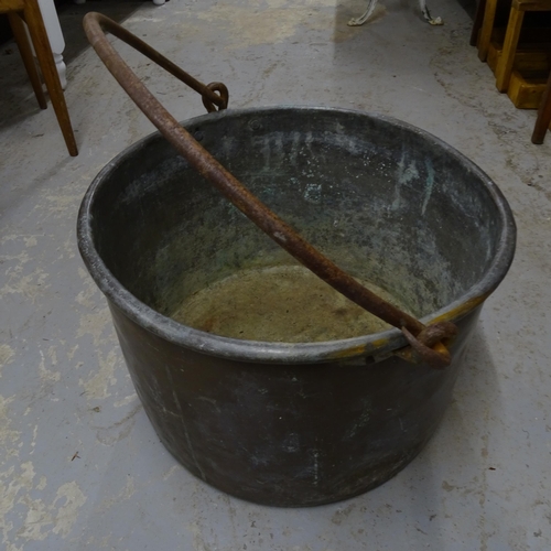 2710 - A large 19th century copper cauldron, with iron swing handle, D47cm, H32cm