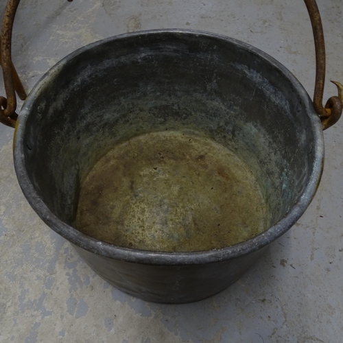 2710 - A large 19th century copper cauldron, with iron swing handle, D47cm, H32cm