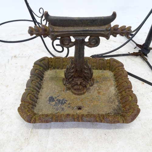 2714 - A cast iron boot scraper, a wirework plant stand and another painted metal plant stand (3)