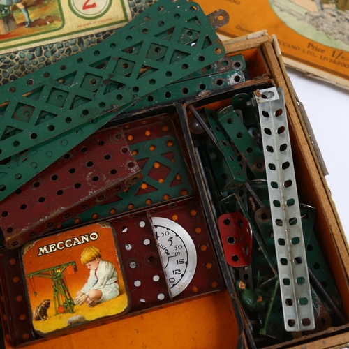 284 - A Meccano accessory outfit, boxed, including 2 tins, and a Meccano standard mechanism catalogue