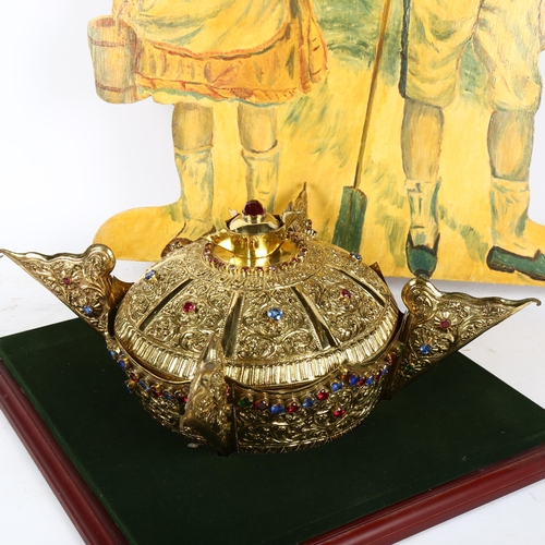 684 - A Tibetan jewelled brass ornamental crown, internal diameter 16.5cm, in display stand, and a painted... 