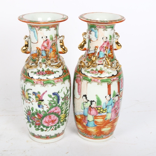 718 - A pair of Chinese Canton vases, with enamelled and gilded decoration, height 20cm