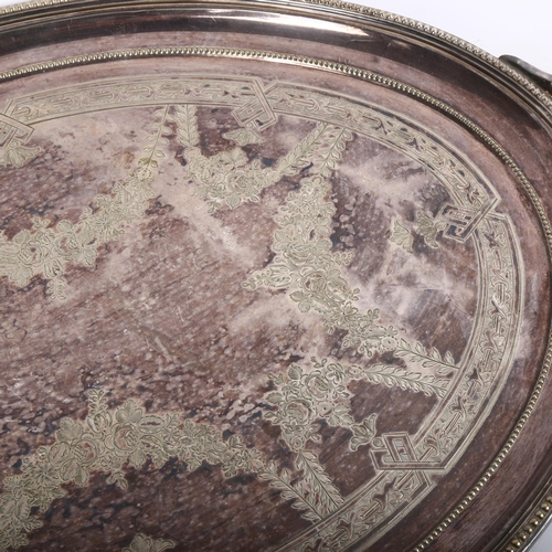 821 - An early 20th century silver plated oval 2-handled tea tray with engraved decoration