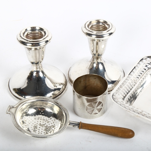 897 - A pair of squat weighted silver candlesticks, a tea strainer, Maltese silver napkin ring etc