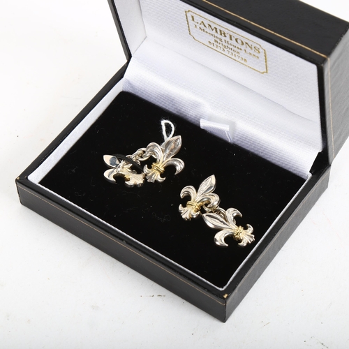 915 - A pair of modern sterling silver fleur de lis cufflinks, maker's marks TK and S, panel length 18.8mm... 