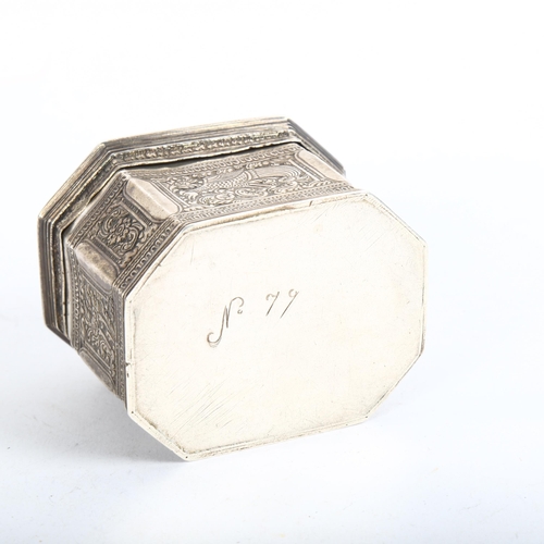 920 - An Indian white metal trinket box of canted form, with scrolled and engraved bird and floral decorat... 