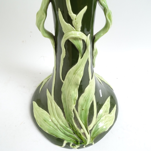 697 - A Continental Art Nouveau pottery jardiniere stand, with applied floral decoration, height 69cm