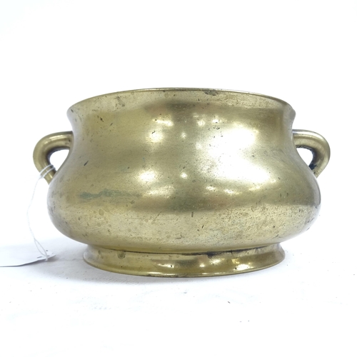 341 - A Chinese bronze censer with scrolled handles, and 6 character mark to the base, height 8.5cm