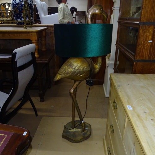 2075 - A decorative floor standing gilt composite floor lamp, in the form of a flamingo with green shade, H... 