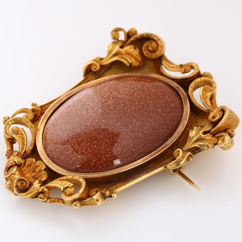 103 - A large 18ct gold goldstone brooch, in Victorian style,  foliate and shell frame set with large oval... 