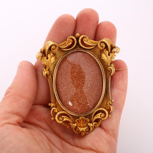 103 - A large 18ct gold goldstone brooch, in Victorian style,  foliate and shell frame set with large oval... 