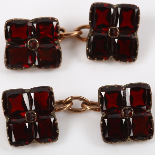 110 - A pair of flat-top garnet cufflinks, unmarked yellow metal settings, panel length 11mm, 4.1g