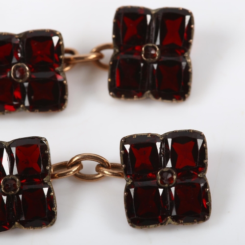 110 - A pair of flat-top garnet cufflinks, unmarked yellow metal settings, panel length 11mm, 4.1g