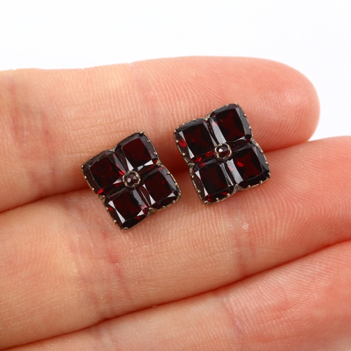 110 - A pair of flat-top garnet cufflinks, unmarked yellow metal settings, panel length 11mm, 4.1g