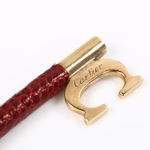 120 - CARTIER - a 9ct gold and red leather key ring fob, signed and numbered 76961, hallmarks London 1978,... 