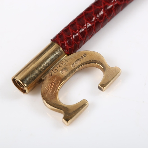 120 - CARTIER - a 9ct gold and red leather key ring fob, signed and numbered 76961, hallmarks London 1978,... 