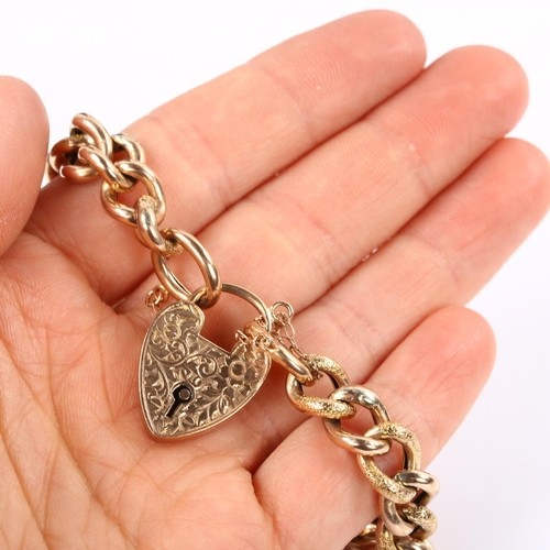 125 - An Antique 9ct rose gold hollow curb link chain bracelet, with floral engraved heart padlock clasp, ... 