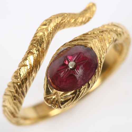 137 - An 18ct gold figural coiled snake/serpent ring, the textured head set with etched cabochon garnet, s... 