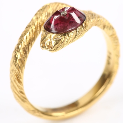 137 - An 18ct gold figural coiled snake/serpent ring, the textured head set with etched cabochon garnet, s... 