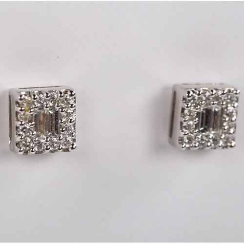 139 - A pair of 18ct white gold diamond cluster earrings, set with baguette and modern round brilliant-cut... 