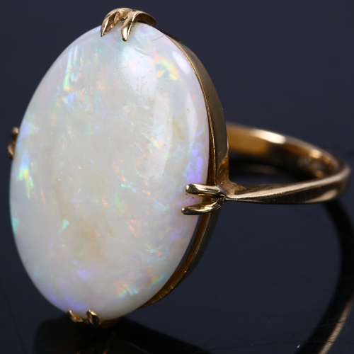 142 - A late 20th century 18ct gold white opal dress ring, set with oval cabochon opal, setting height 21.... 