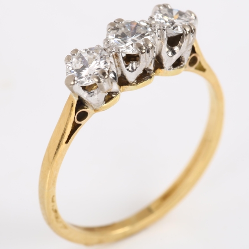 144 - A three stone diamond ring, unmarked gold settings, with modern round brilliant-cut diamonds, total ... 