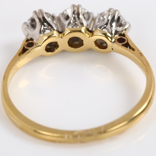 144 - A three stone diamond ring, unmarked gold settings, with modern round brilliant-cut diamonds, total ... 