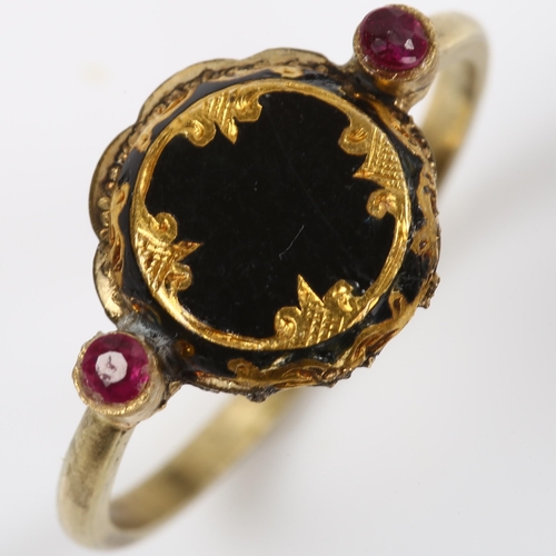 151 - An Antique black enamel and ruby mourning ring, unmarked gold settings with engraved closed-back hea... 